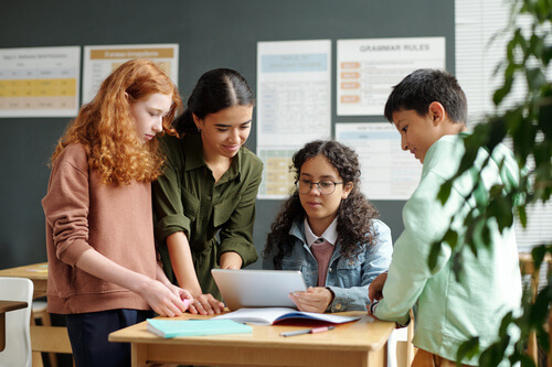 Teacher helping students with school assignments